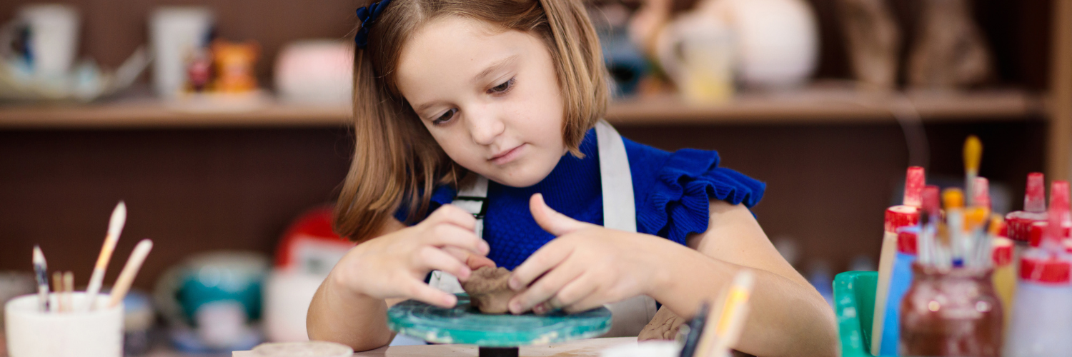 Header image featuring an elementary school-aged girl throwing clay in a classroom. Header for blog on independent schools and effective annual appeals.